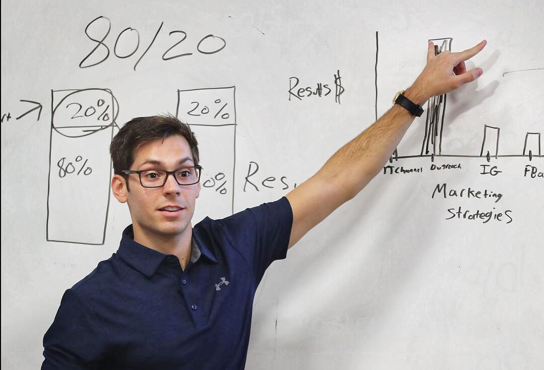 Paul pointing to a whiteboard.